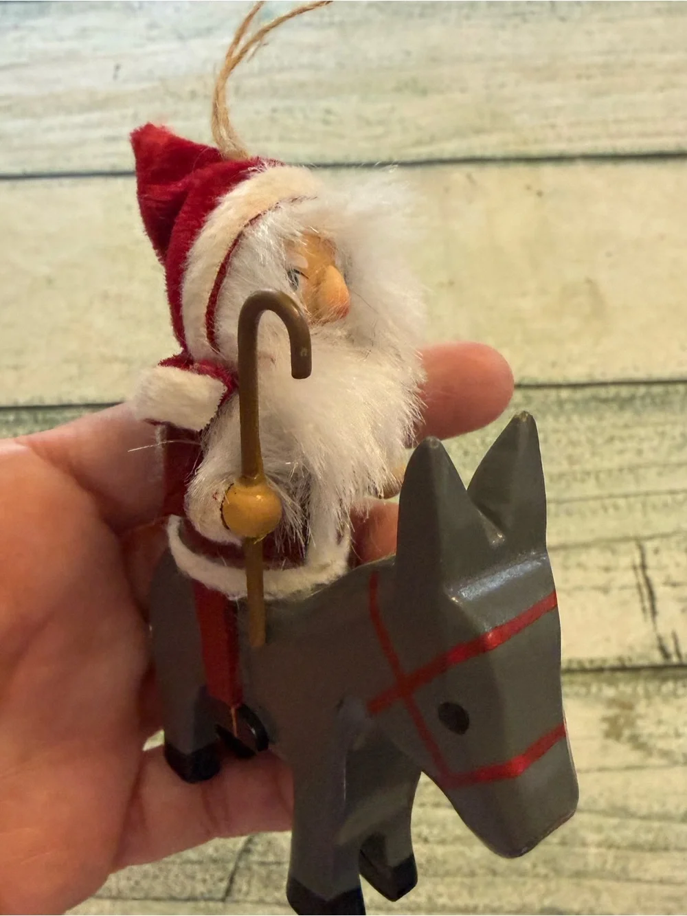 Vintage Christmas wood Santa riding a donkey horse ornament.